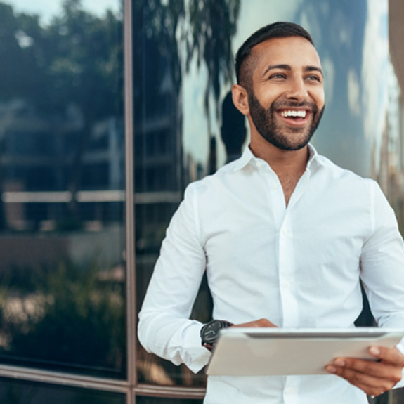 Young male professional smiling at work