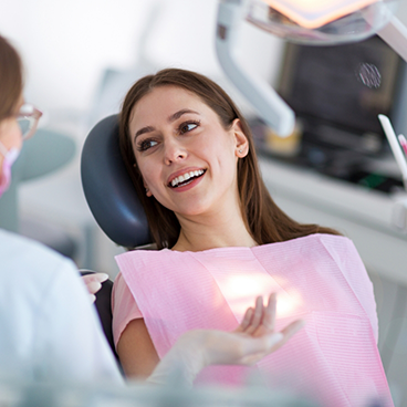 Female patient in dental chair smiling