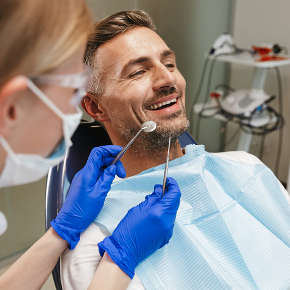 Bearded dental patient about to have teeth examined