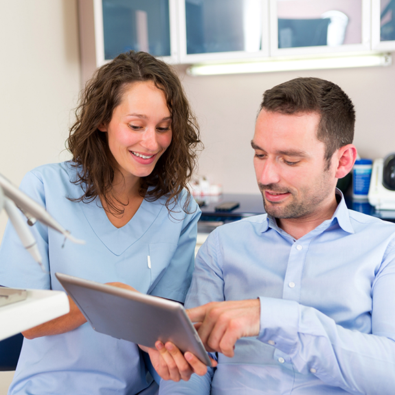 Dentist showing patient a tablet