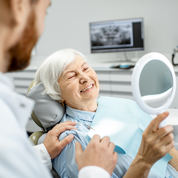 Illustration of senior woman checking smile in handheld mirror