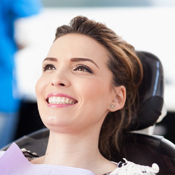 Smiling woman sitting back in dental chair