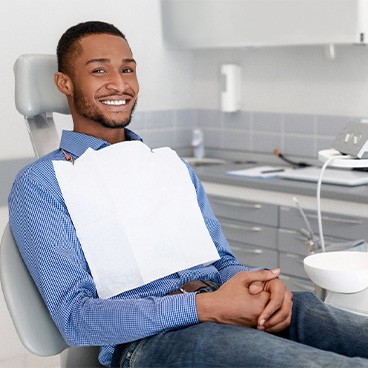 Man in blue shirt sitting in dental chair