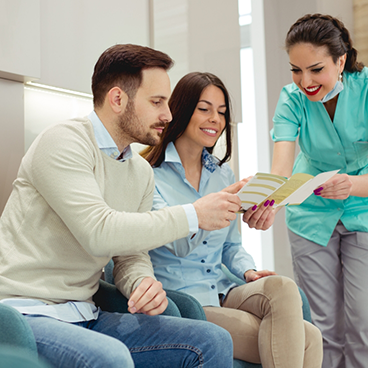 Dental team member showing couple a form