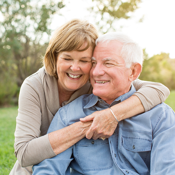 Senior couple standing together outside and smiling