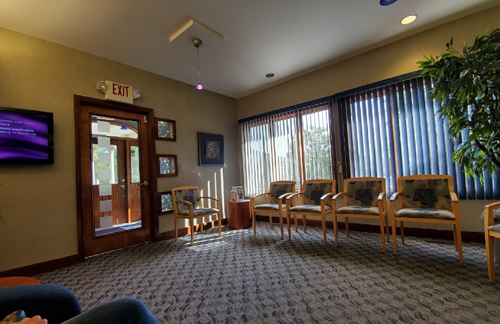 Chairs lined up inside waiting room of dental practice