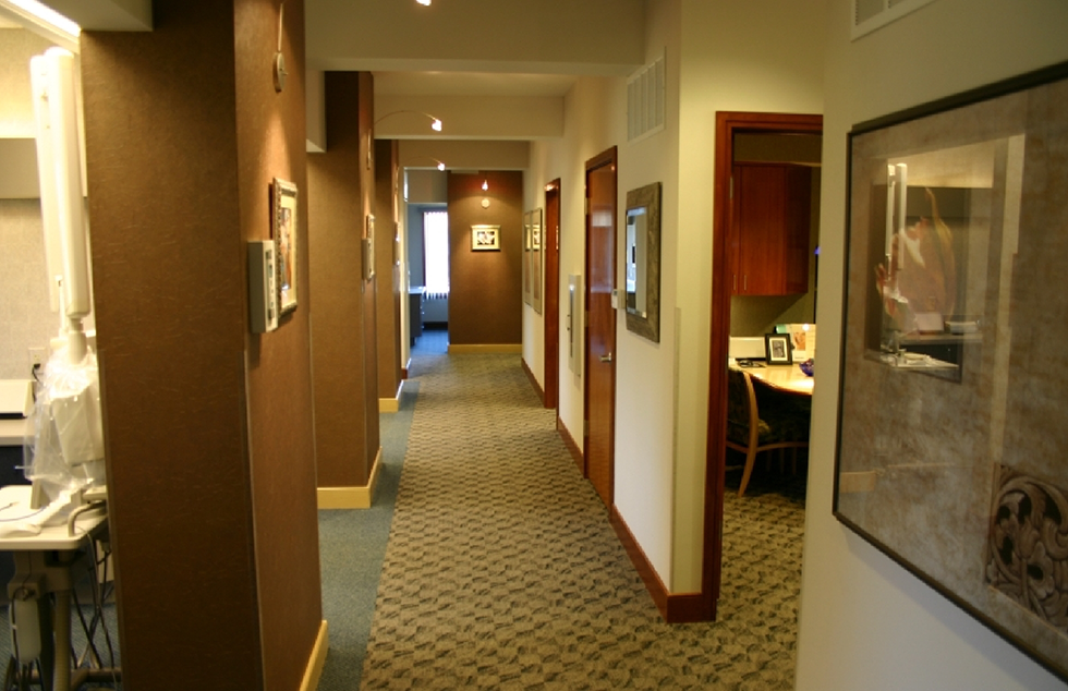 Hallway of dental office with doors leading to treatment areas