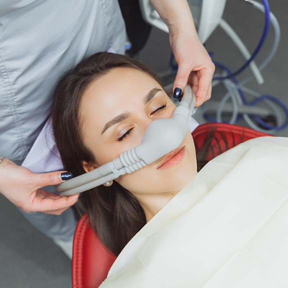 Female patient having mask placed over nose