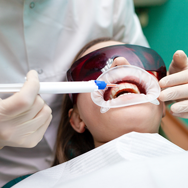 Patient receiving in office teeth whitening treatment