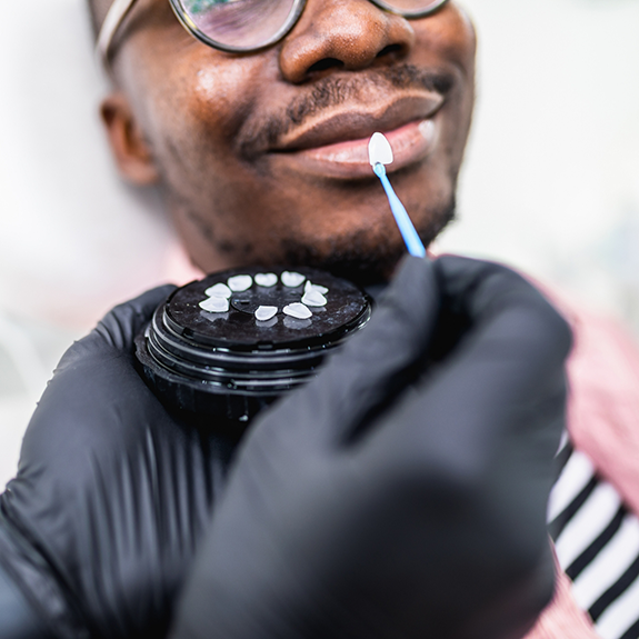 Man with glasses about to have teeth shade matched