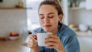 Woman enjoying a cup of coffee in her kitchen